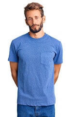 Fototapeta premium Handsome blond man with beard wearing casual clothes with serious expression on face. simple and natural looking at the camera.