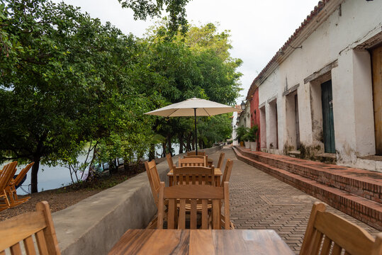 Tables of a restaurant in an exterior corridor on the banks of the Magdalena river in the town of Mompox. Colombia.