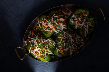 Stuffed peppers made with ground pork , cheese , marinara sauce, onions, and herbs. Garnished with...