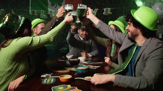 People celebrating the St patrick day with green beer drink into a pub