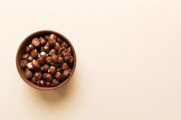 Wooden bowl full of hazelnuts on table background. Healthy eating concept. Super foods