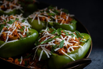 Stuffed peppers made with ground pork , cheese , marinara sauce, onions, and herbs. Garnished with parmesan cheese and fresh parsley.