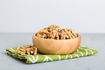 Fresh healthy walnuts in bowl on colored table background. Top view Healthy eating bertholletia concept. Super foods