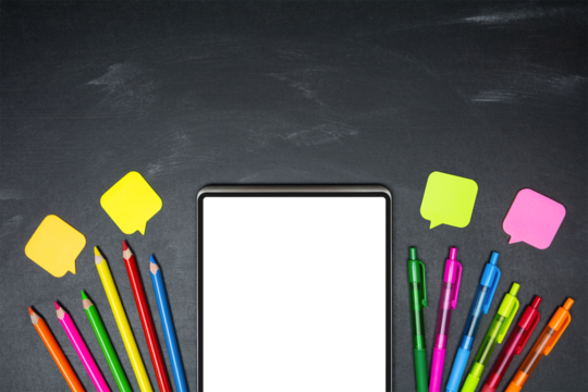 Digital tablet with blank transparent screen and school supplies on blackboard background, top view, copy space. E-learning concept