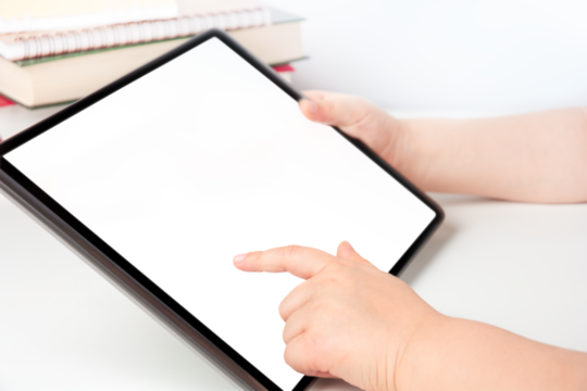 Child's hands holding digital tablet and touching blank transparent screen, e-learning concept