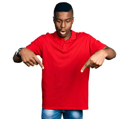 Young african american man wearing casual red t shirt pointing down with fingers showing...