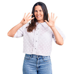 Young beautiful brunette woman wearing casual shirt showing and pointing up with fingers number nine while smiling confident and happy.