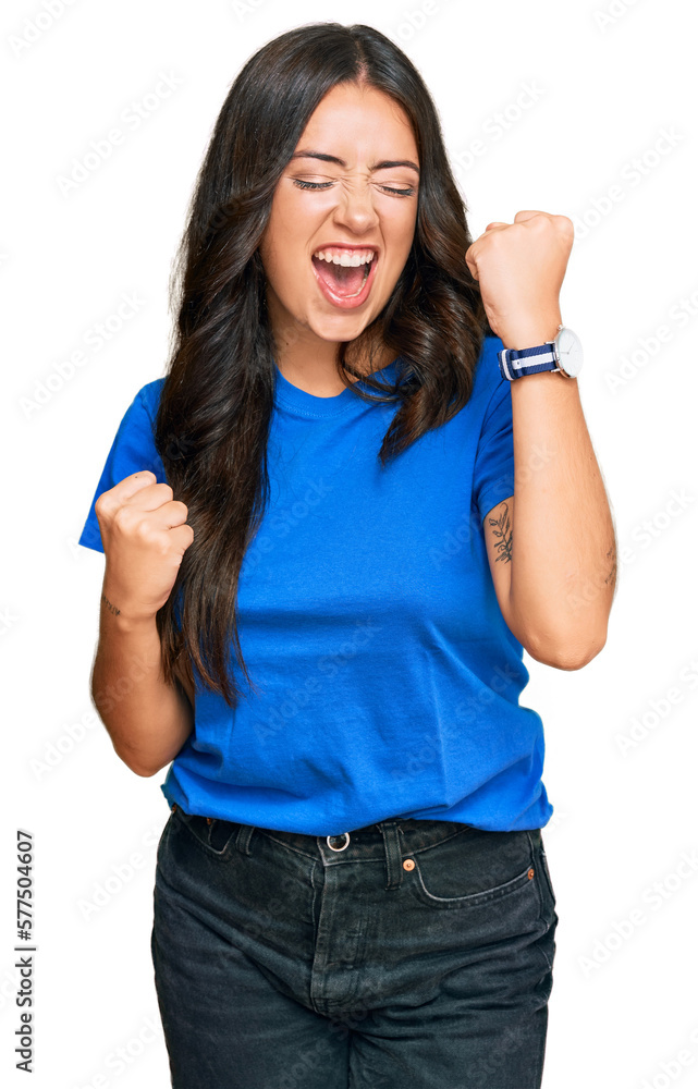 Sticker Beautiful brunette young woman wearing casual clothes celebrating surprised and amazed for success with arms raised and eyes closed. winner concept.