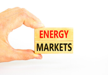 Energy markets symbol. Concept words Energy markets on wooden block. Beautiful white table white background. Businessman hand. Business energy markets concept. Copy space.