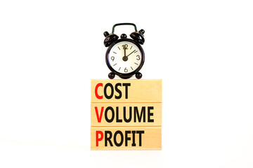 CVP cost volume profit symbol. Concept words CVP cost volume profit on wooden blocks on a beautiful white background. Black alarm clock. Business and CVP cost volume profit concept. Copy space.