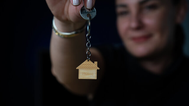 house sale. Happy woman buying new house with mortgage. Woman gets new keys to her house