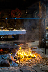Vintage fireplace for cooking food inside the old wooden viking longhouse in the reconstruction of...