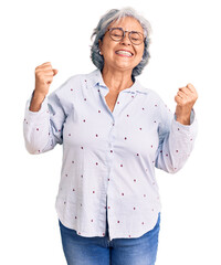Senior woman with gray hair wearing casual business clothes and glasses very happy and excited...