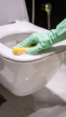 Cleaning and disinfecting the toilet bowl with sponge detergent