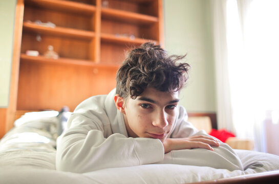 portrait of young boy in his bedroom