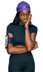Young african american woman wearing sportswear thinking looking tired and bored with depression problems with crossed arms.