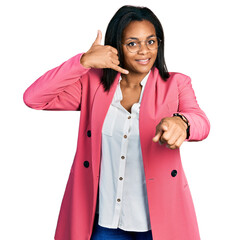 Beautiful hispanic woman wearing business jacket smiling doing talking on the telephone gesture and...