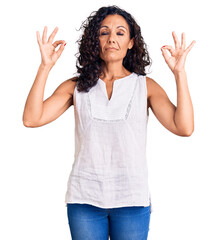 Middle age beautiful woman wearing casual sleeveless t shirt relax and smiling with eyes closed doing meditation gesture with fingers. yoga concept.