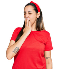 Young hispanic woman wearing casual clothes bored yawning tired covering mouth with hand. restless and sleepiness.