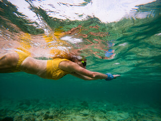 woman snorkeling in clear tropical sea