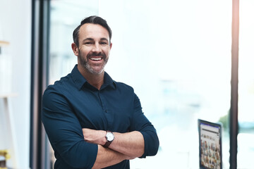Im building my own empire. Portrait of a mature businessman standing in his office.