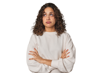 Radiant young woman with stunning curls tired of a repetitive task.