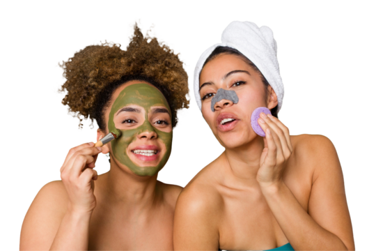 Two friends pamper themselves with facial treatments for a relaxing spa day at home, with laughter and enjoyment. Nourishing their skin for a glowing, confident look.