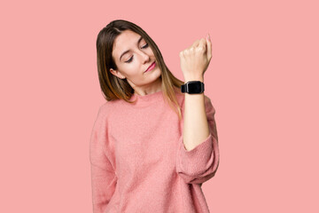 A young woman admiring her sleek and modern smartwatch for convenient timekeeping.