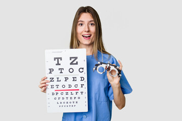 A young female optometrist holding eyeglasses and a vision test, ensuring proper eye care.