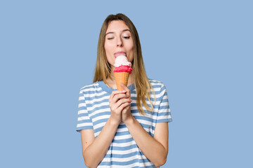 Young woman eating an ice cream isolated