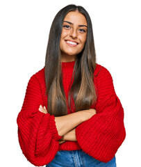 Beautiful hispanic woman wearing casual clothes happy face smiling with crossed arms looking at the...