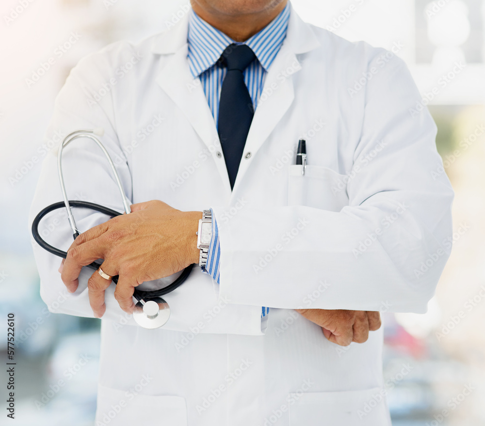 Wall mural Committed to helping you stay healthy. Cropped shot of a doctor holding a stethoscope and folding his arms.