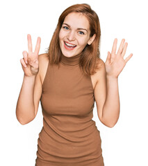 Young caucasian woman wearing casual clothes showing and pointing up with fingers number seven while smiling confident and happy.