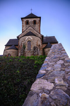 Small medieval church in Laval France, Mayenne with wall in foreground