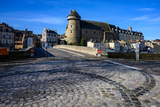Old bridge over Mayenne River in Laval, France with decorative cobblestones