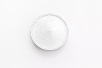 Isolated natural sweetener Erythritol, produced by fermentation from corn, called dextrose in ceramic bowl on white background. Sugar substitute. Horizontal plane, copy space for text,top view