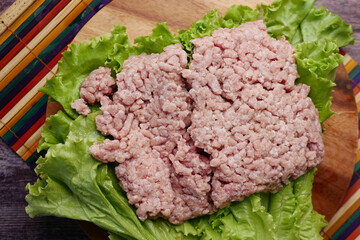 close up of beef mince on a chopping board on table 