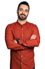 Young hispanic man with beard wearing casual shirt happy face smiling with crossed arms looking at the camera. positive person.