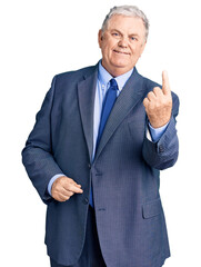 Senior grey-haired man wearing business jacket beckoning come here gesture with hand inviting welcoming happy and smiling