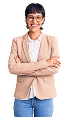 Young brunette woman with short hair wearing business jacket and glasses happy face smiling with...