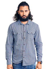 Young arab man wearing casual clothes depressed and worry for distress, crying angry and afraid. sad expression.