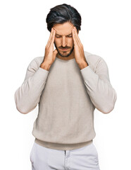 Young hispanic man wearing casual clothes suffering from headache desperate and stressed because...