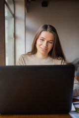 Young women working with laptop while sitting at café