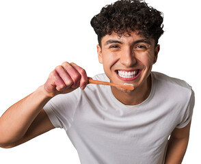 A mindful young man practices eco-conscious dental hygiene using a sustainable bamboo toothbrush for his oral health and the planet's well-being.