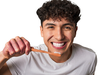 A mindful young man practices eco-conscious dental hygiene using a sustainable bamboo toothbrush for his oral health and the planet's well-being.