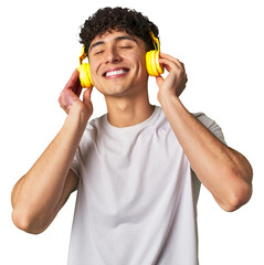 A young man enjoys his favorite tunes in high-quality sound, using wireless headphones for a relaxing and entertaining audio experience.