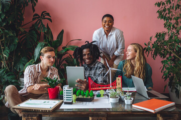 International group of students working on modern urban architecture project with renewable green energy source, alternative electricity, waste recycling. Excited and happy to win ecology contest