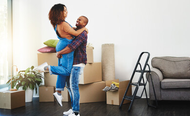 To a wonderful beginning with the perfect person. Shot of an attractive young couple moving house.