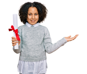 Young little girl with afro hair holding graduate degree diploma celebrating victory with happy smile and winner expression with raised hands