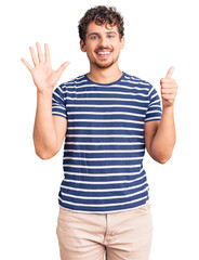Young handsome man with curly hair wearing casual clothes showing and pointing up with fingers number six while smiling confident and happy.